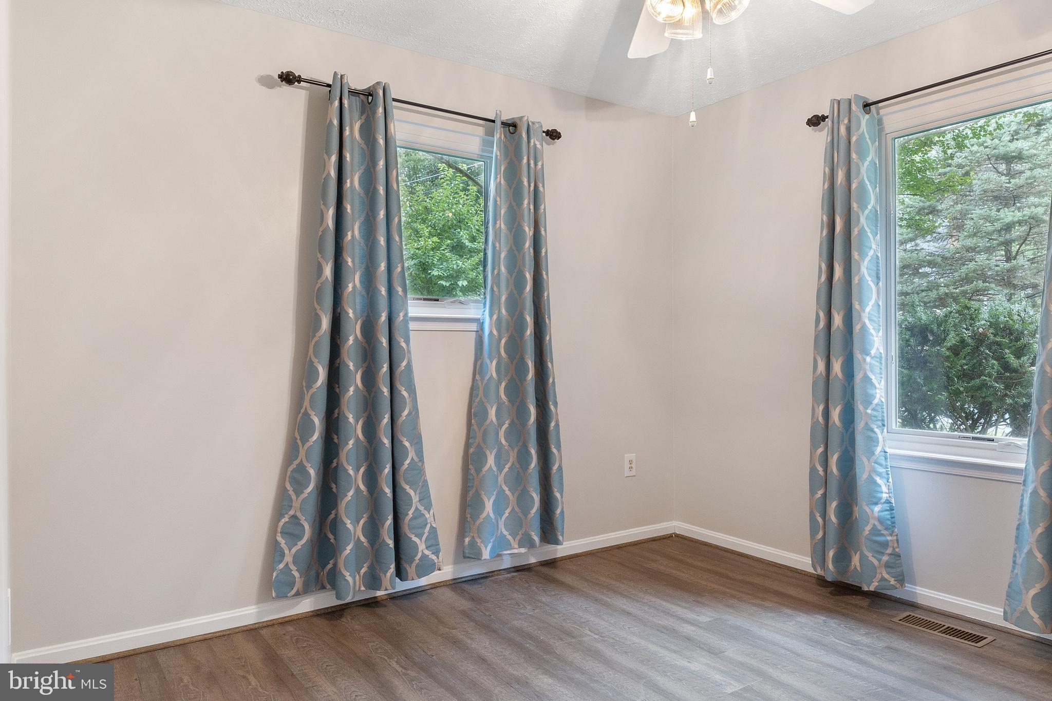 11316 Commanche Road Lusby, MD 20657 - Photo 23 of 68 an empty room with wooden floor and a window