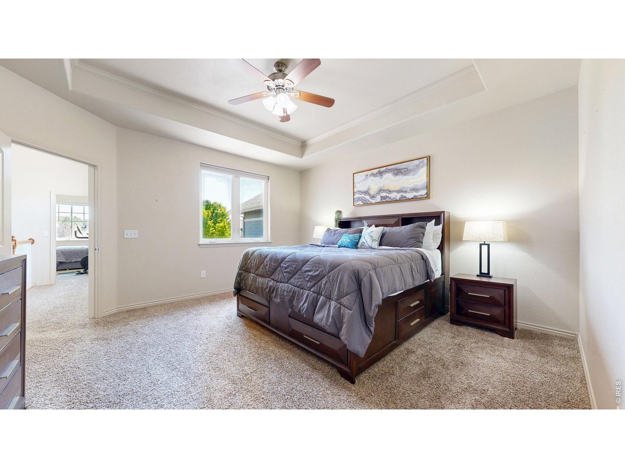 4672 West 20th Road, Unit 413 Greeley, CO 80634 - Photo 19 of 37 a living room with a bed furniture and chandelier