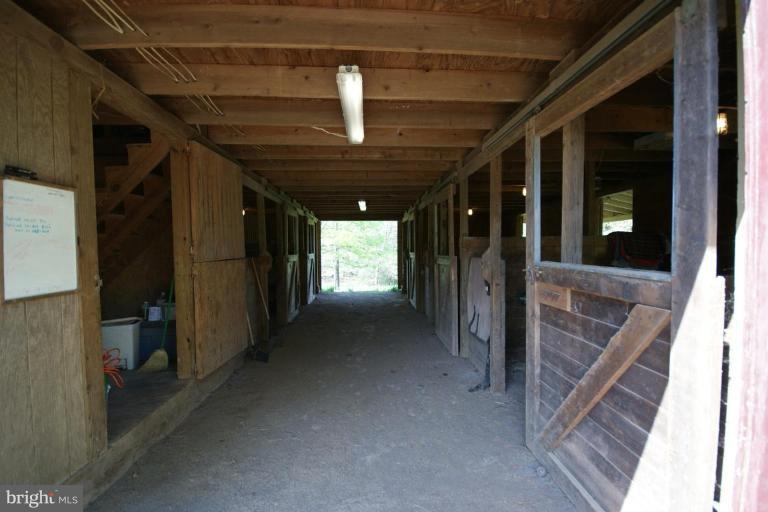 7396 Clifton Road Clifton, VA 20124 - Photo 5 of 30 The center aisle, tack and feed room and stalls