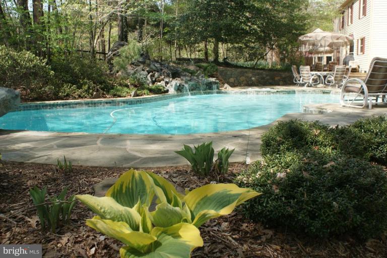 7396 Clifton Road Clifton, VA 20124 - Photo 9 of 30 A stone waterfall cascades into the pool