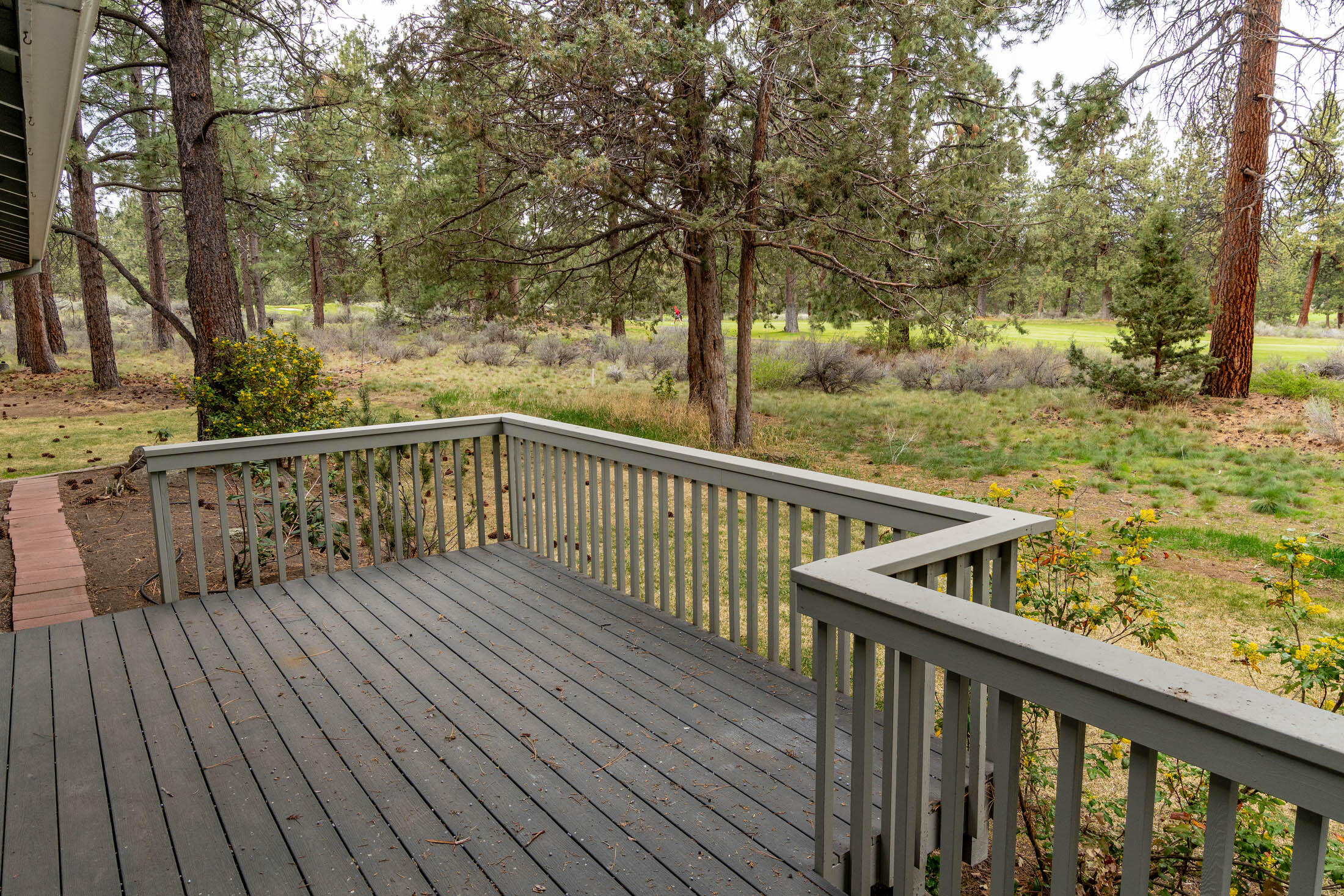 20316 Donkey Sled Road Bend, OR 97702 - Photo 30 of 50 a view of deck with wooden floor and trees