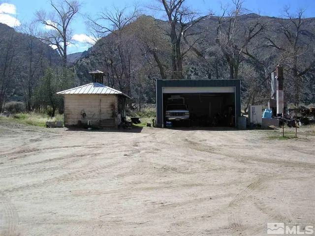 a view of a house with a yard and garage