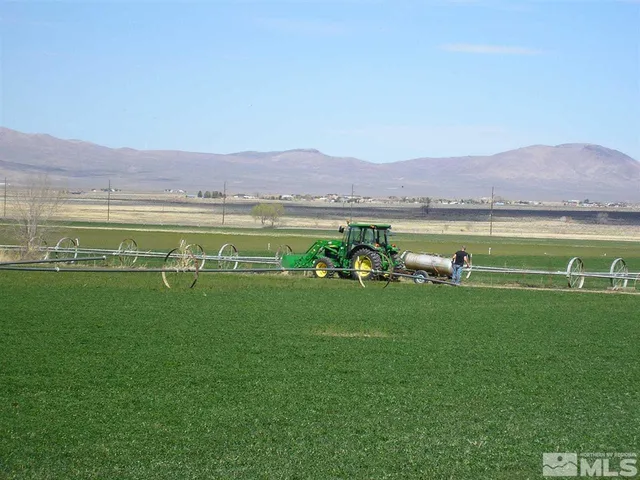 a view of a green field with an ocean view