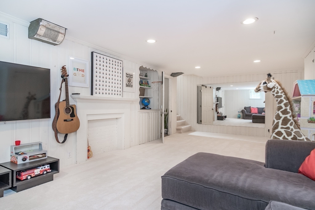 29 Brookfield Road Wellesley, MA 02481 - Photo 18 of 23 a living room with furniture a flat screen tv and a white bed
