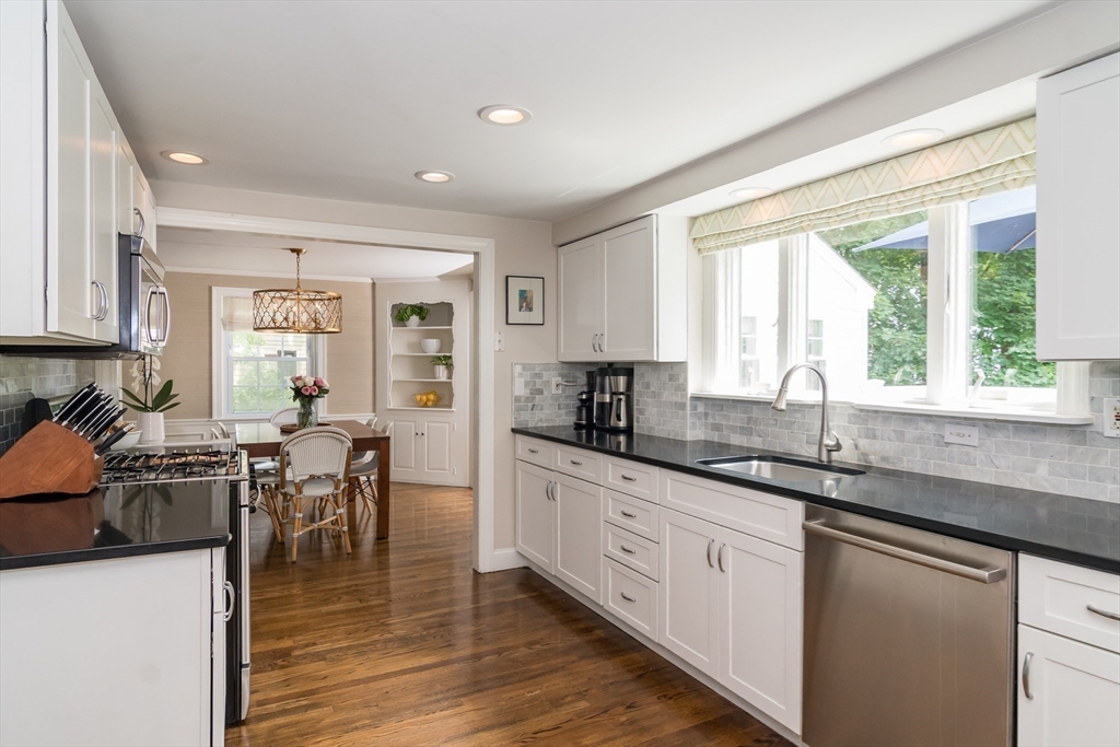 29 Brookfield Road Wellesley, MA 02481 - Photo 3 of 23 a kitchen with granite countertop a stove a sink a dining table and chairs