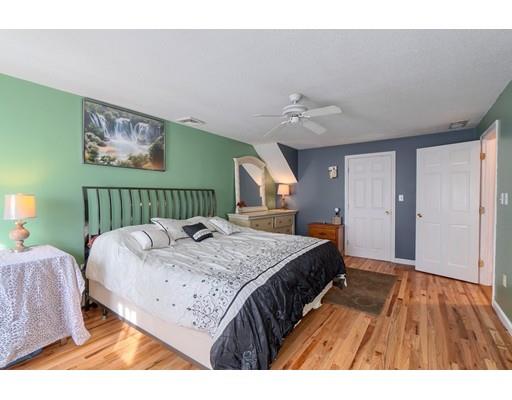 11 Partridge Road Dracut, MA 01826 - Photo 11 of 40 a bedroom with a bed and a chandelier