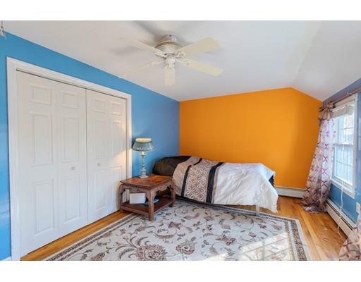 11 Partridge Road Dracut, MA 01826 - Photo 13 of 40 a bedroom with a bed and a bookshelf with wooden floor