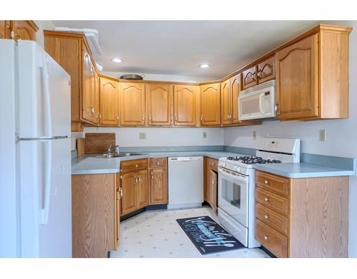 11 Partridge Road Dracut, MA 01826 - Photo 19 of 40 a kitchen with stainless steel appliances granite countertop a stove a sink dishwasher and a refrigerator