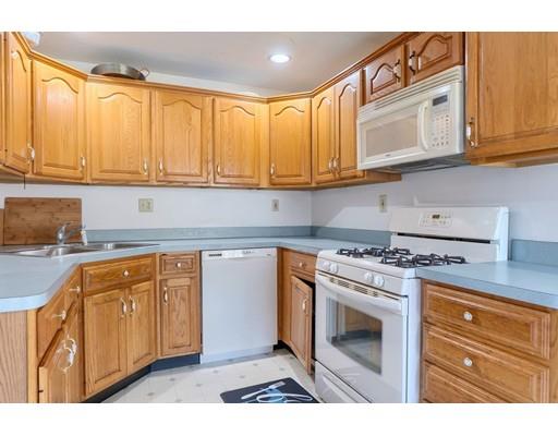 11 Partridge Road Dracut, MA 01826 - Photo 21 of 40 a kitchen with stainless steel appliances granite countertop a stove a sink and cabinets