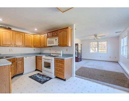 11 Partridge Road Dracut, MA 01826 - Photo 23 of 40 a kitchen with stainless steel appliances granite countertop a stove a sink and a microwave
