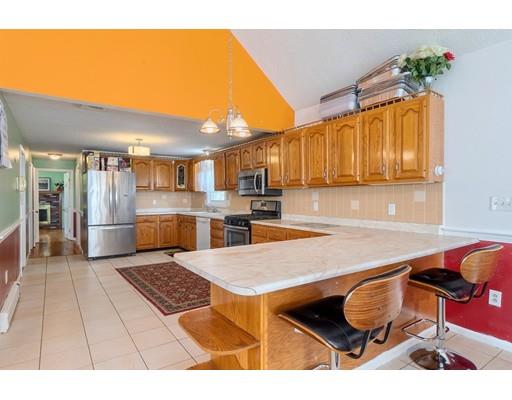 11 Partridge Road Dracut, MA 01826 - Photo 6 of 40 a kitchen with stainless steel appliances kitchen island granite countertop a refrigerator and stove