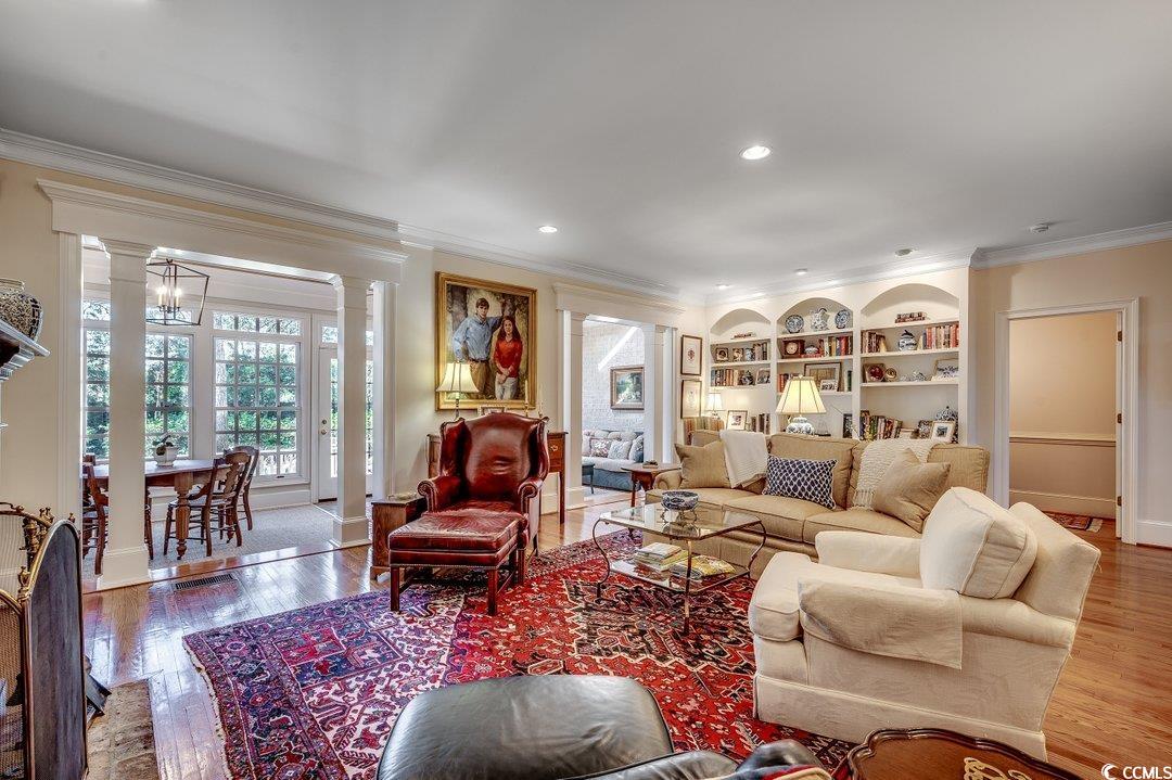 12 Chapin Circle Myrtle Beach, SC 29572 - Photo 14 of 39 Living area featuring hardwood / wood-style flooring, decorative columns, built in shelves, and ornamental molding