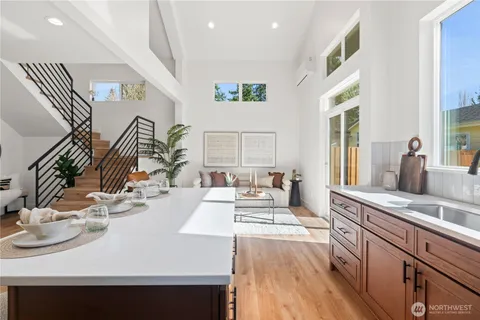 a view of a kitchen area with furniture and wooden floor