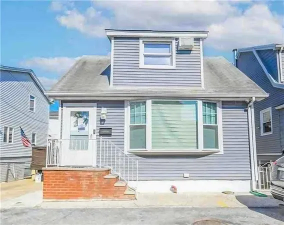 a view of a house with a small backyard