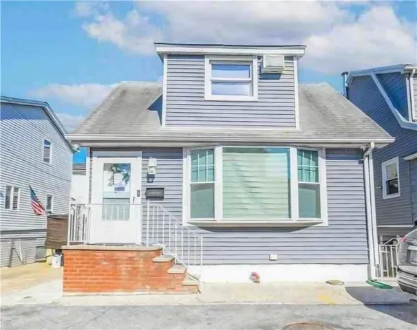 a view of a house with a small backyard