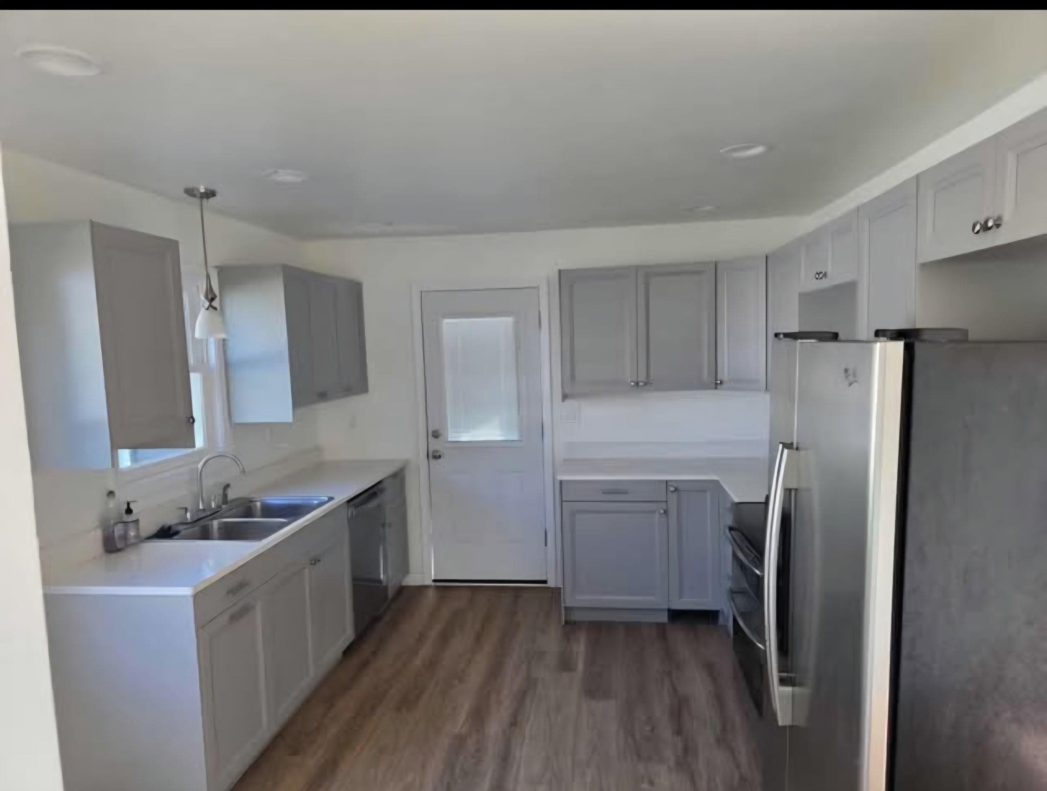 704 Spruce Street Savanna, IL 61074 - Photo 4 of 19 a kitchen with a refrigerator sink and cabinets
