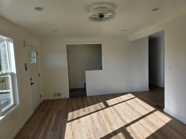 an empty room with wooden floor