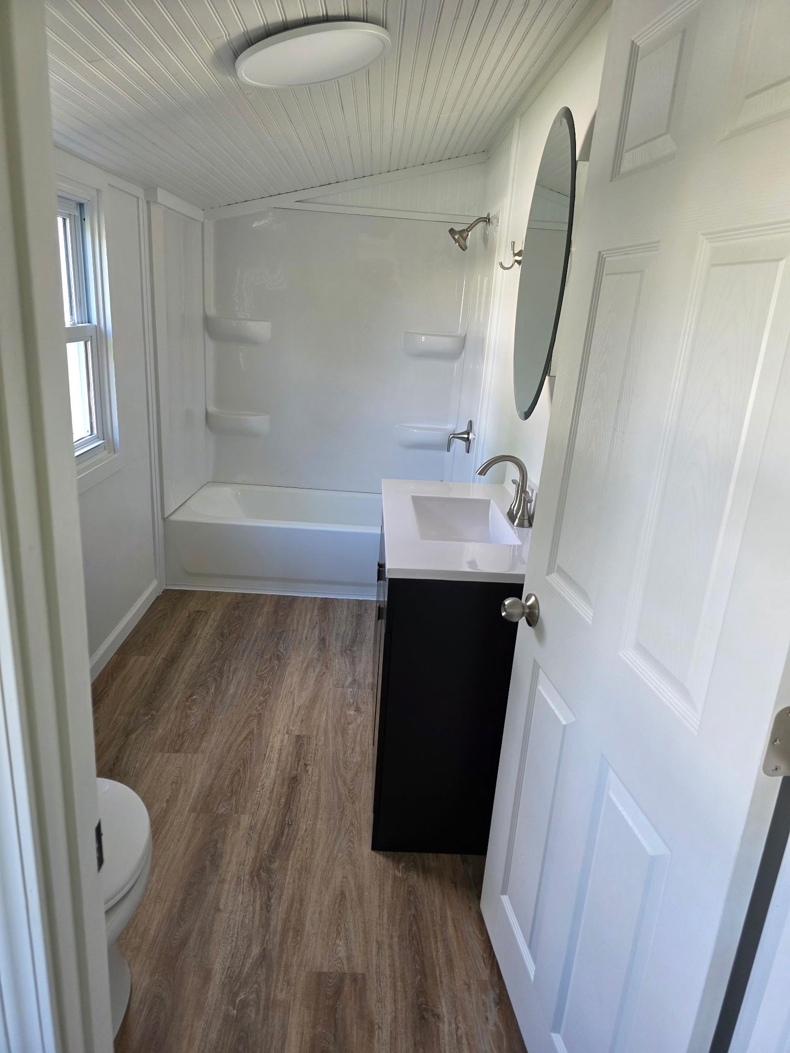704 Spruce Street Savanna, IL 61074 - Photo 8 of 19 a bathroom with a sink and a mirror