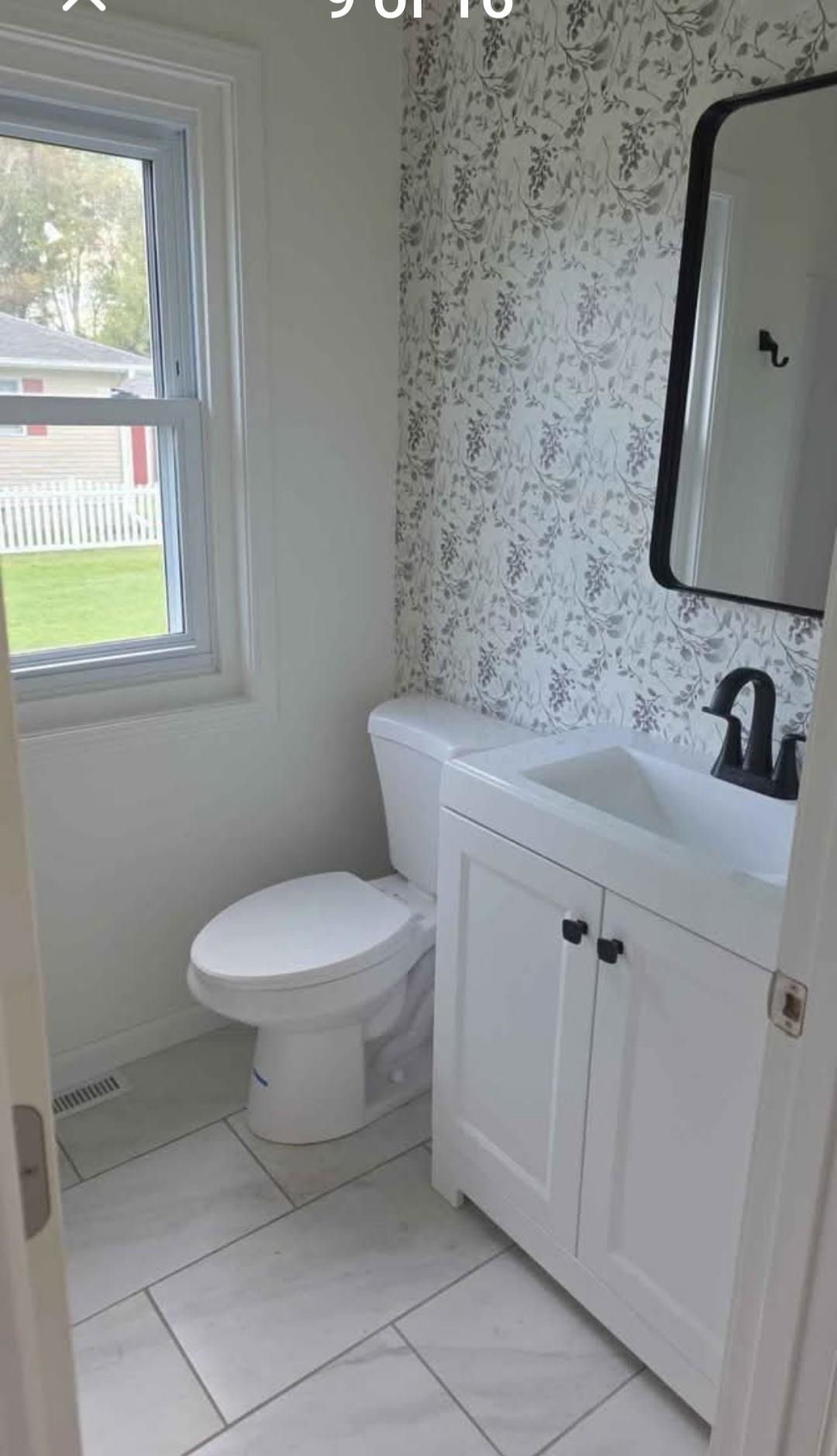 704 Spruce Street Savanna, IL 61074 - Photo 10 of 19 a bathroom with a toilet sink and mirror