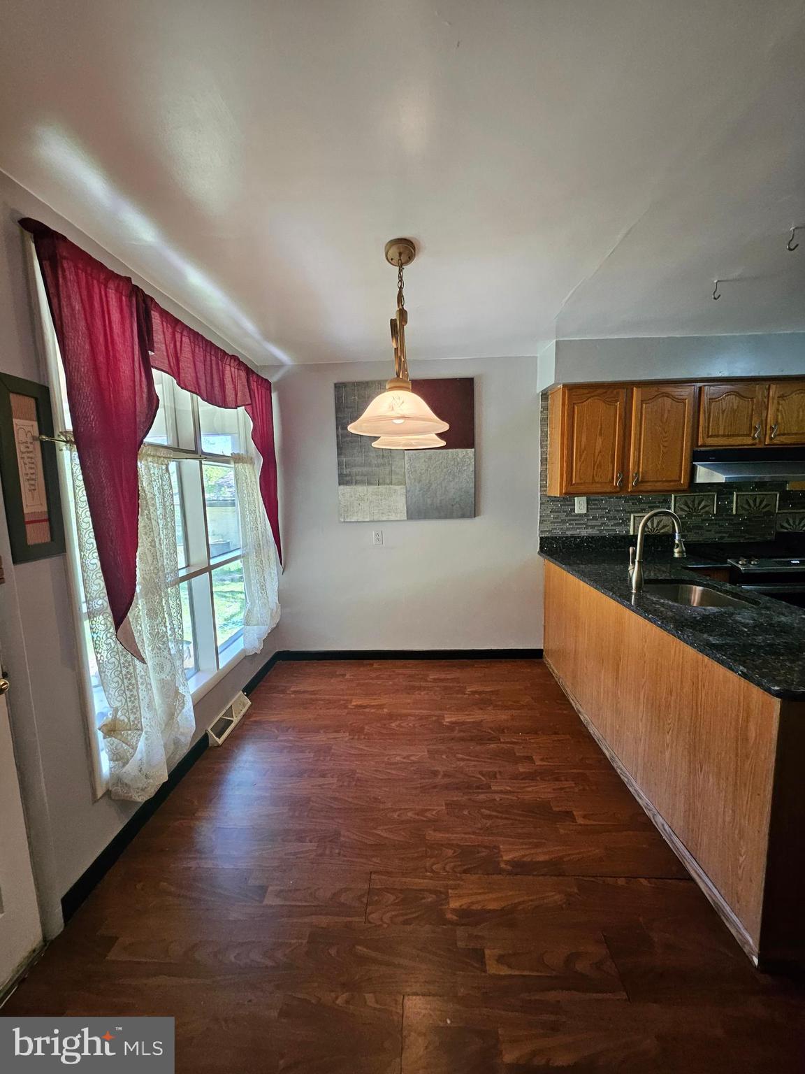 148 Church Road Elkins Park, PA 19027 - Photo 12 of 33 a view of a kitchen with a sink and dishwasher with wooden floor
