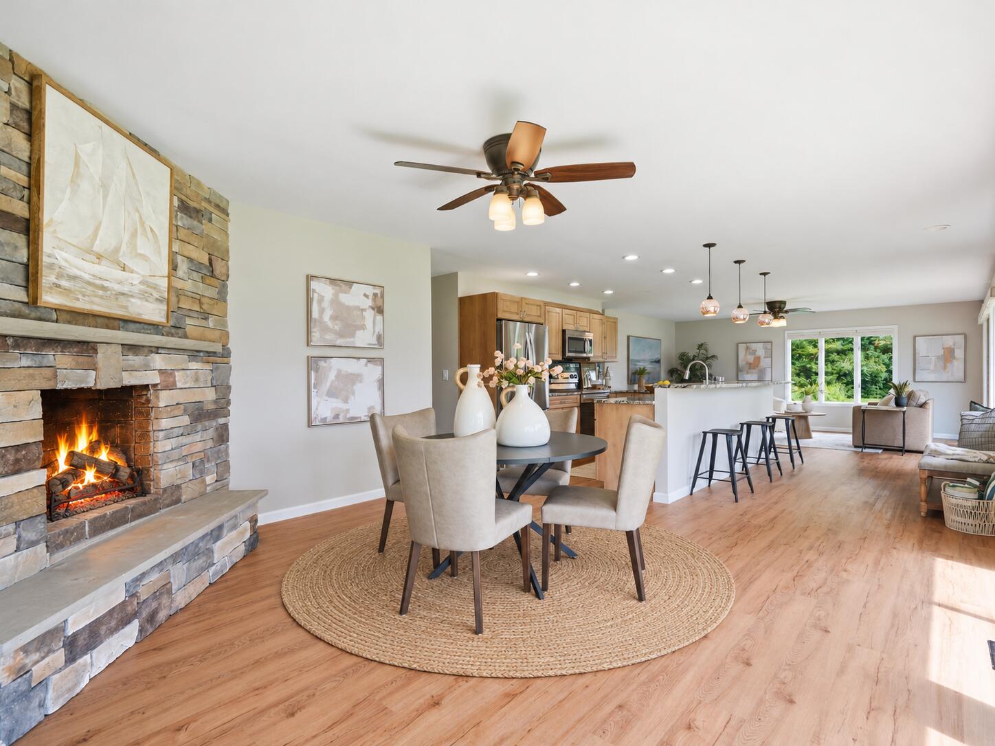 11243 Wynns Road Pinckney, MI 48169 - Photo 3 of 39 Warm fireplace and woven dining rug