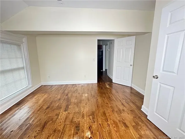 a view of an empty room and wooden floor