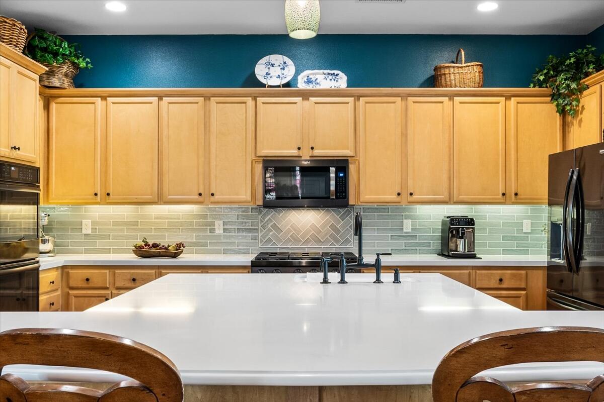 81836 Bowstring Circle La Quinta, CA 92253 - Photo 13 of 55 a kitchen with stainless steel appliances granite countertop a sink a stove and a microwave