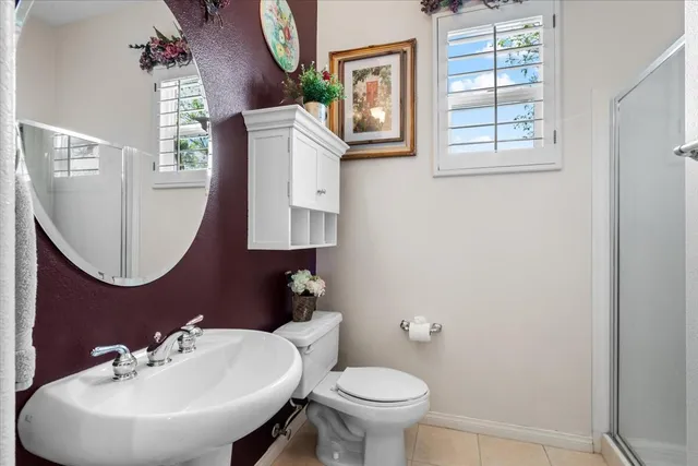 a spacious bathroom with a tub a sink and a large window