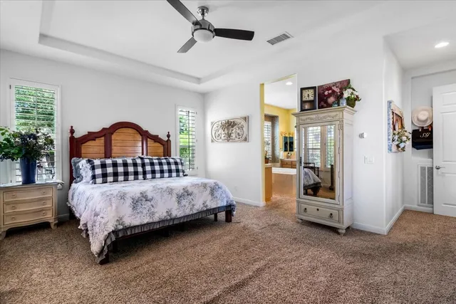 a spacious bathroom with a tub sink and mirror