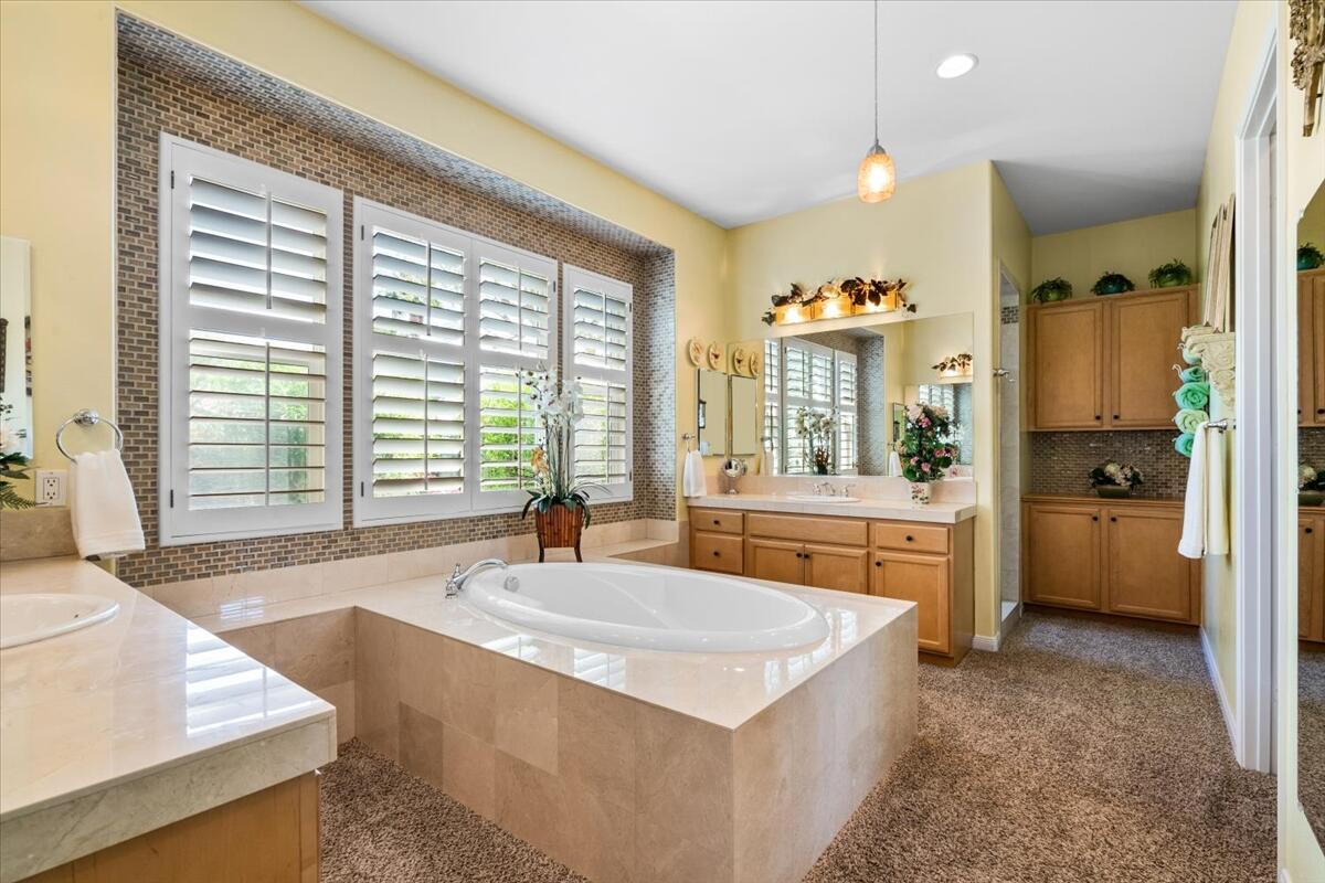 81836 Bowstring Circle La Quinta, CA 92253 - Photo 26 of 56 a spacious bathroom with a tub a sink and a large window