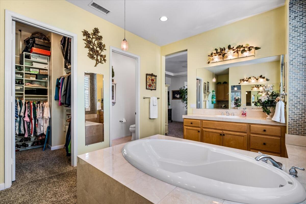 81836 Bowstring Circle La Quinta, CA 92253 - Photo 28 of 56 a spacious bathroom with a tub sink and mirror
