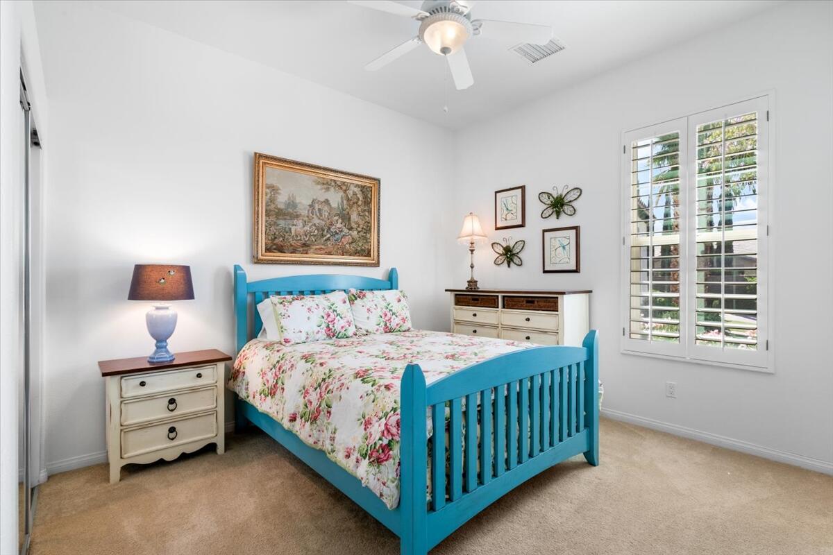81836 Bowstring Circle La Quinta, CA 92253 - Photo 30 of 56 a bedroom with a bed and a chandelier