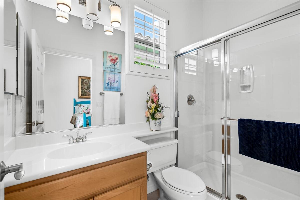 81836 Bowstring Circle La Quinta, CA 92253 - Photo 32 of 56 a bathroom with a sink a toilet a large mirror and shower