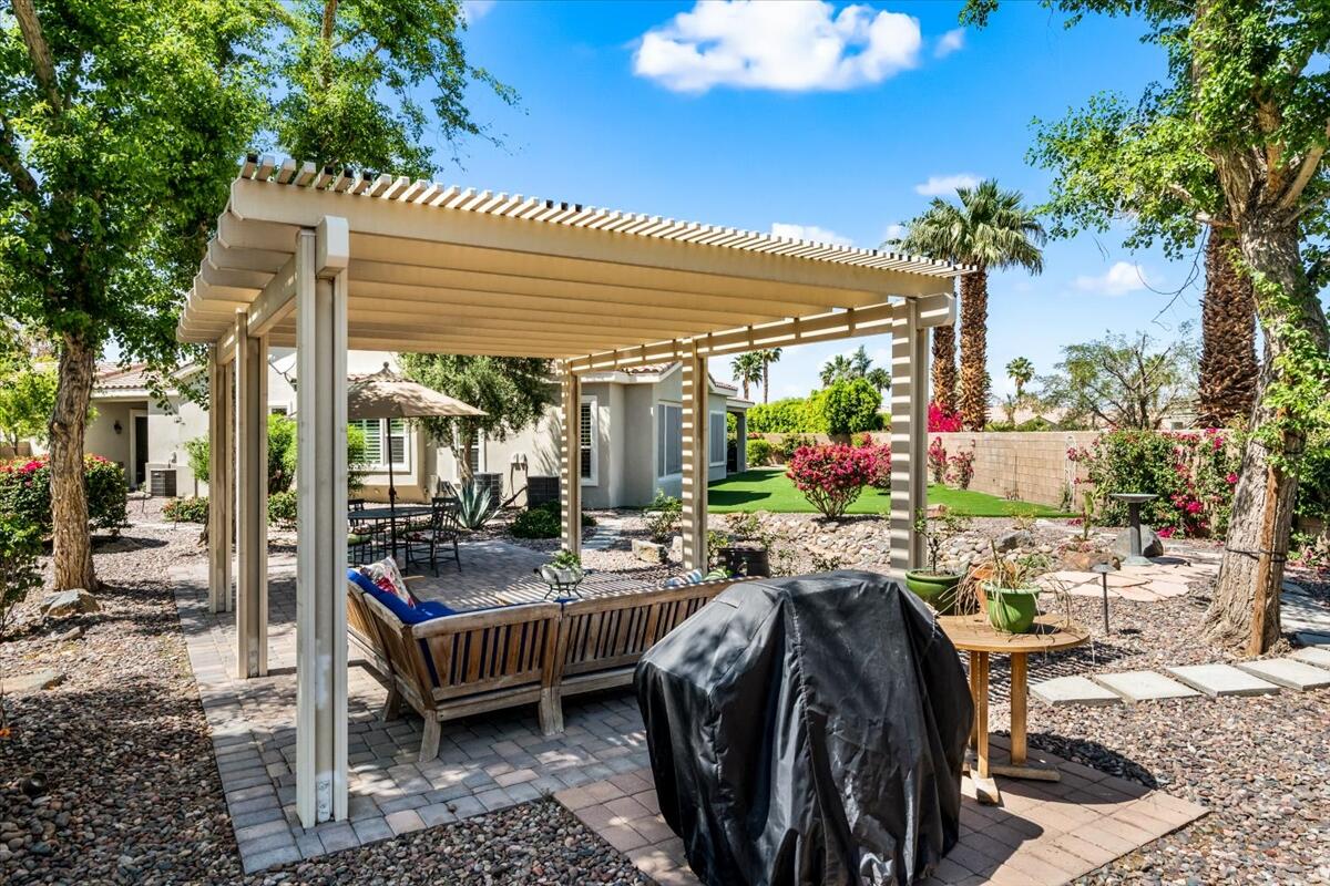 81836 Bowstring Circle La Quinta, CA 92253 - Photo 39 of 56 a view of a patio with table and chairs potted plants and large tree