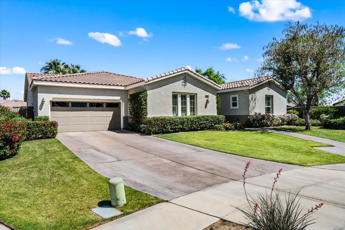 81836 Bowstring Circle La Quinta, CA 92253 - Photo 49 of 56 a front view of a house with a yard and garage