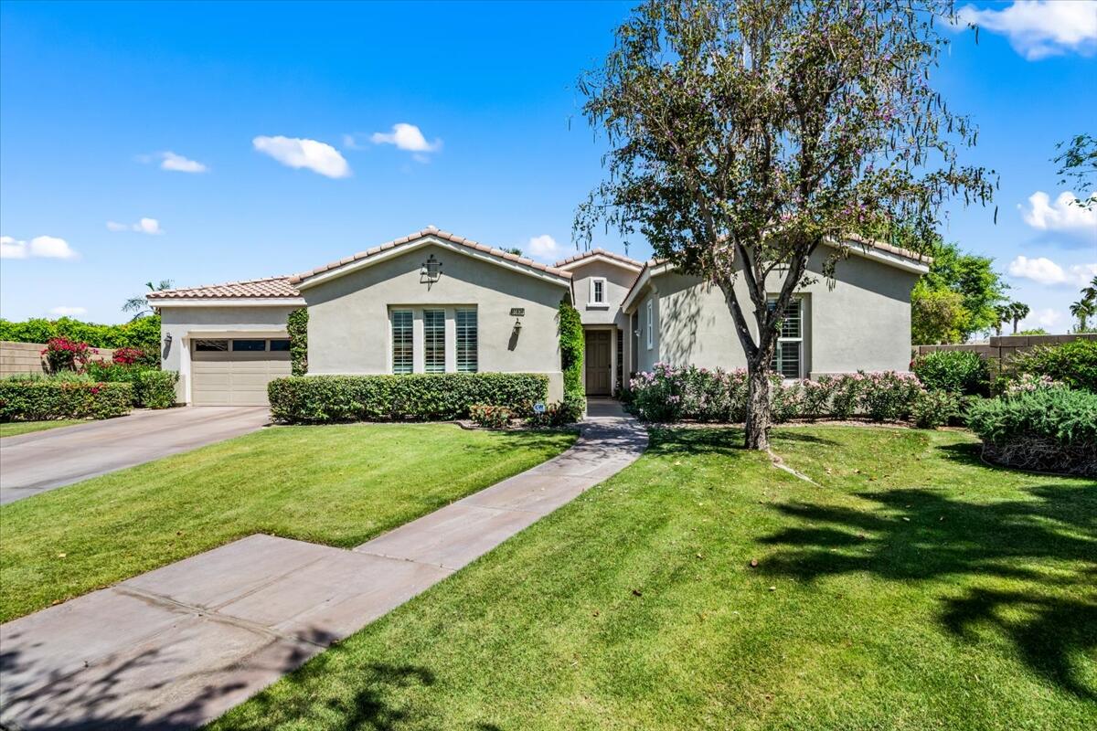 81836 Bowstring Circle La Quinta, CA 92253 - Photo 5 of 56 a front view of a house with a yard and trees