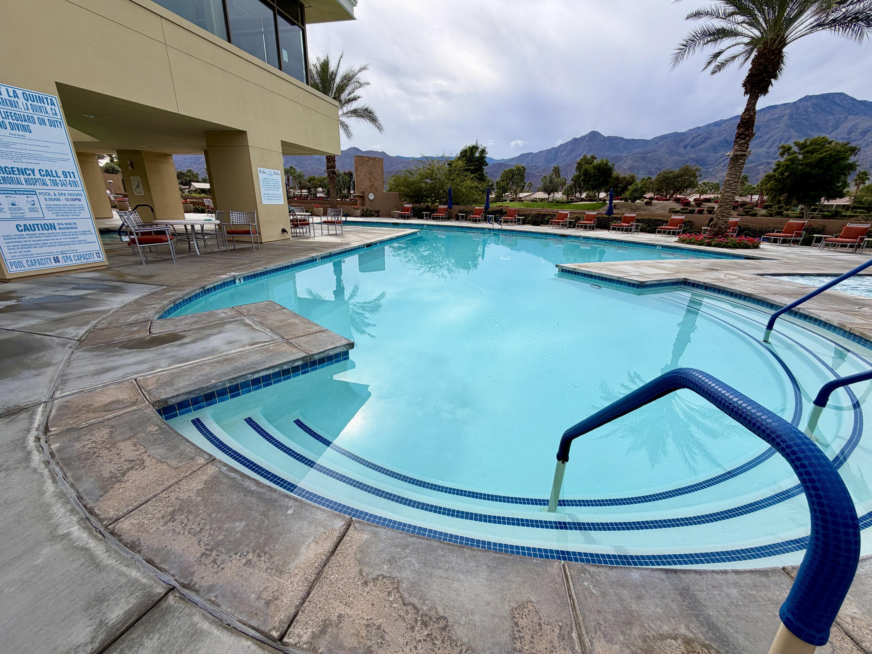 81836 Bowstring Circle La Quinta, CA 92253 - Photo 56 of 56 a view of a swimming pool with lawn chairs and a barbeque