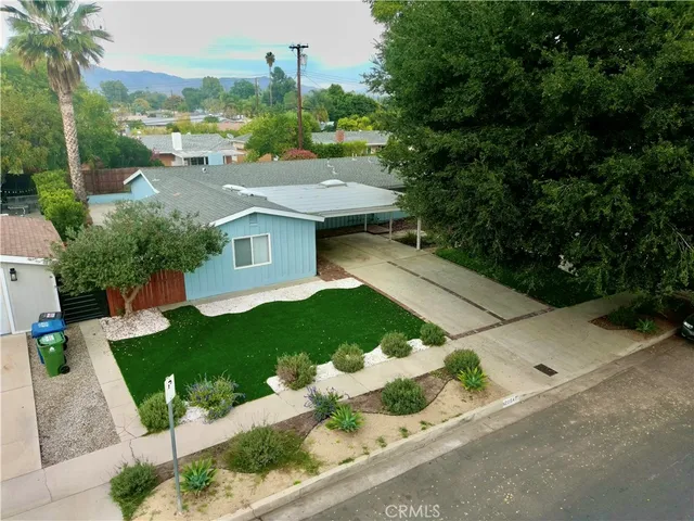 a aerial view of a house with a yard and plants