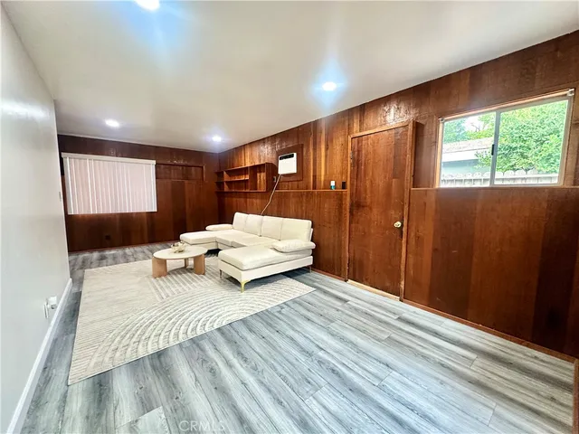 a large kitchen with stainless steel appliances kitchen island granite countertop a refrigerator a sink and white cabinets