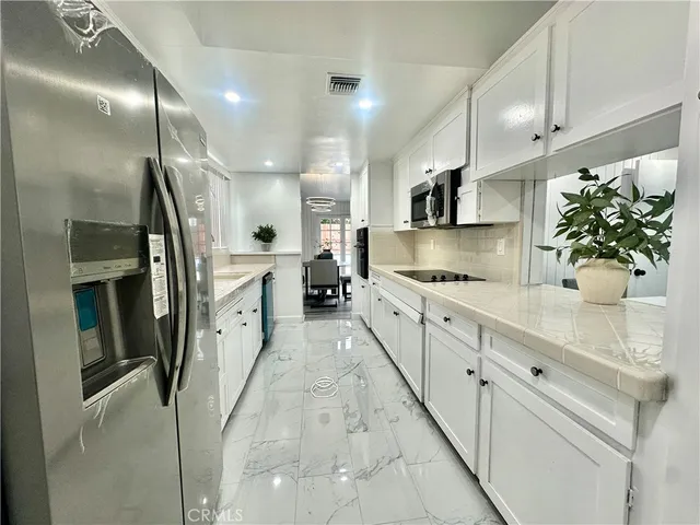 a kitchen with a sink and cabinets