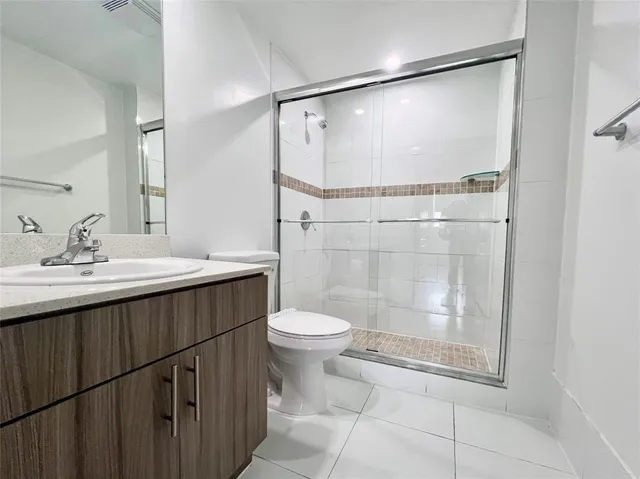 a bathroom with a sink mirror and a toilet