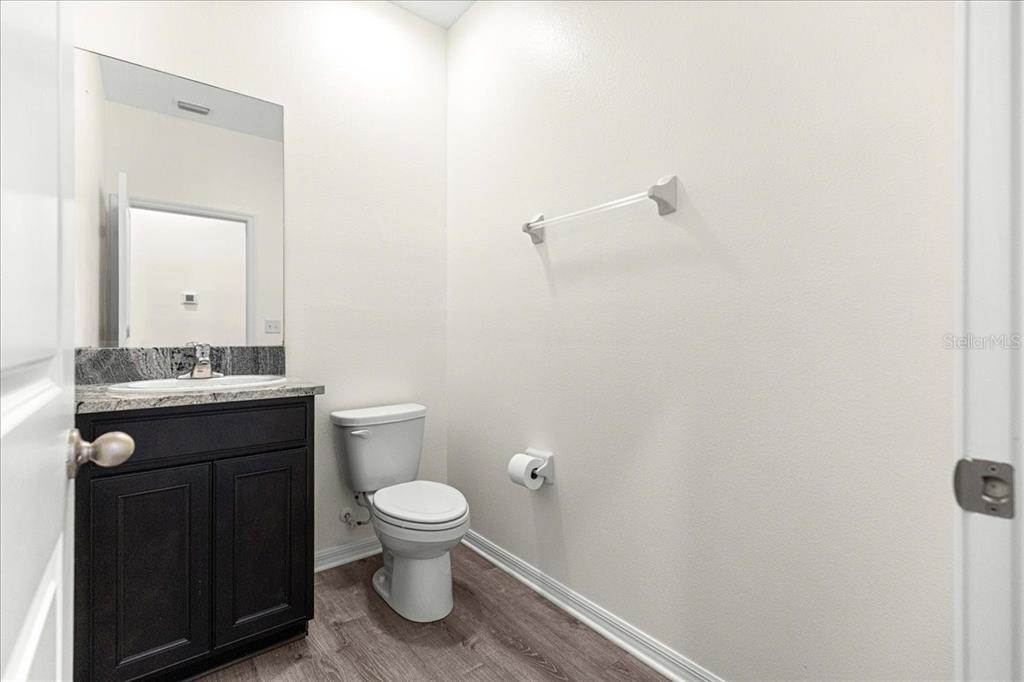 5851 Southwest 85th Place Ocala, FL 34476 - Photo 41 of 57 a bathroom with a toilet a sink and mirror