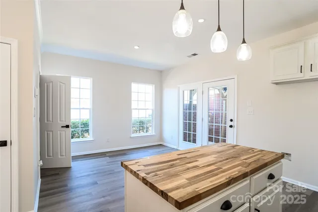 a room with pool table and windows