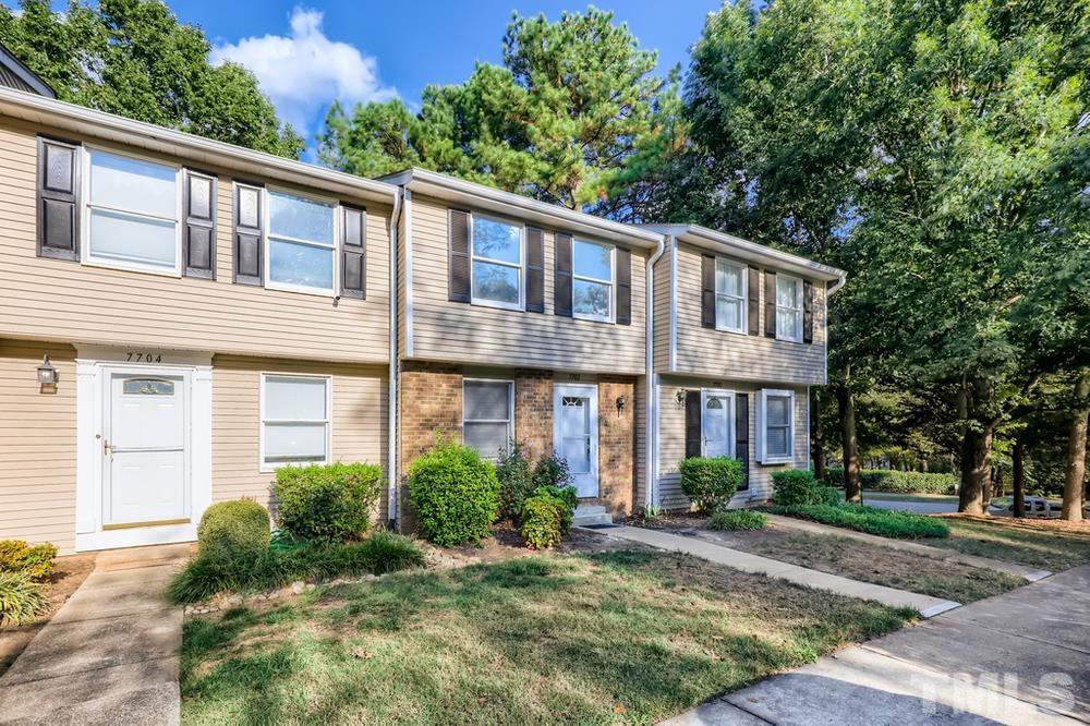 7702 Ohmann Court Raleigh, NC 27615 - Photo 2 of 28 a front view of a house with garden