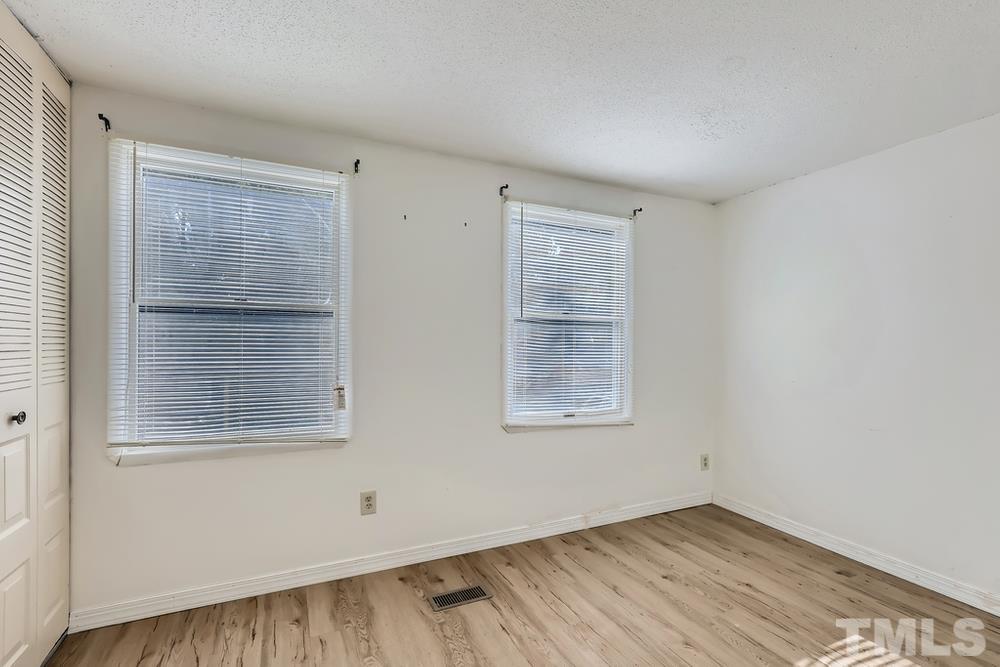 7702 Ohmann Court Raleigh, NC 27615 - Photo 20 of 28 an empty room with windows