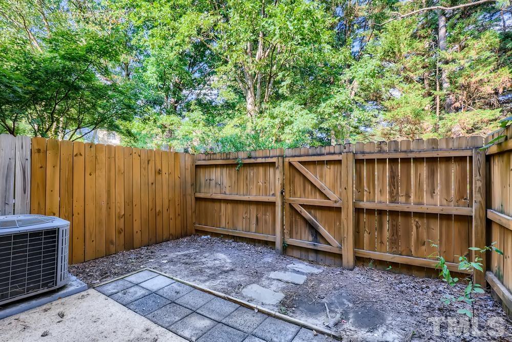 7702 Ohmann Court Raleigh, NC 27615 - Photo 27 of 28 a view of backyard with tub and trees