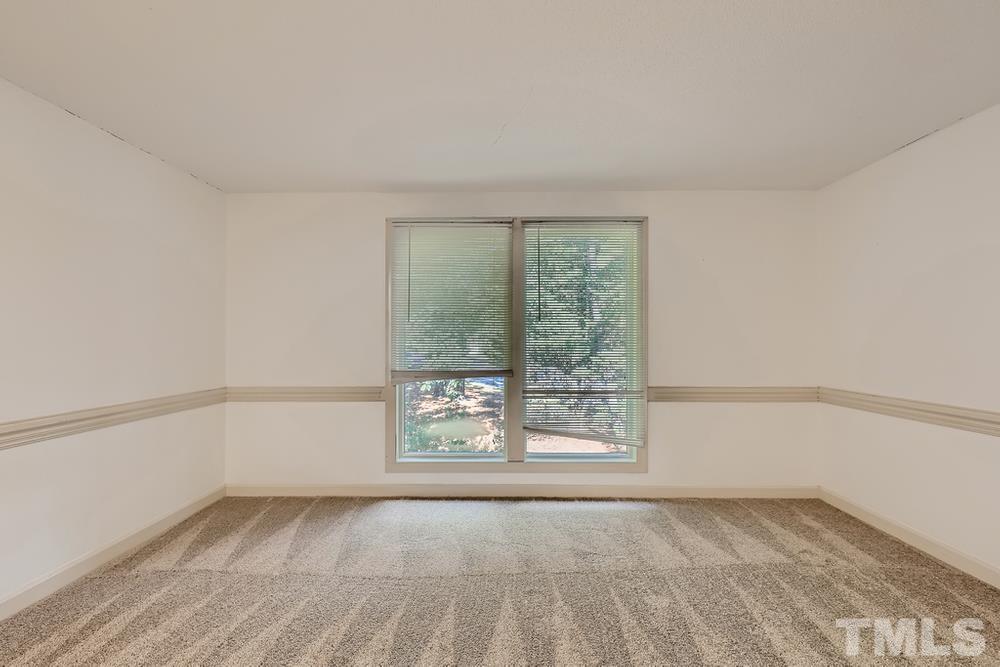 7702 Ohmann Court Raleigh, NC 27615 - Photo 4 of 28 an empty room with a window