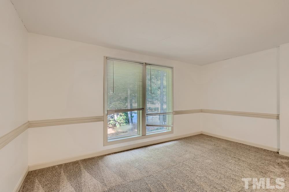 7702 Ohmann Court Raleigh, NC 27615 - Photo 5 of 28 an empty room with windows