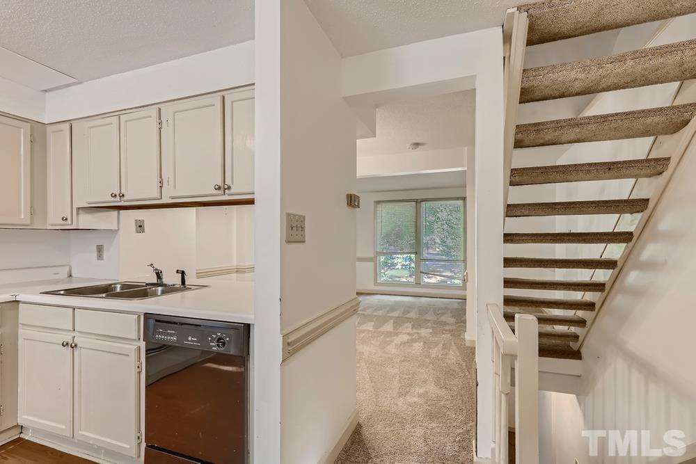 7702 Ohmann Court Raleigh, NC 27615 - Photo 10 of 28 a view of a kitchen with appliances and cabinets