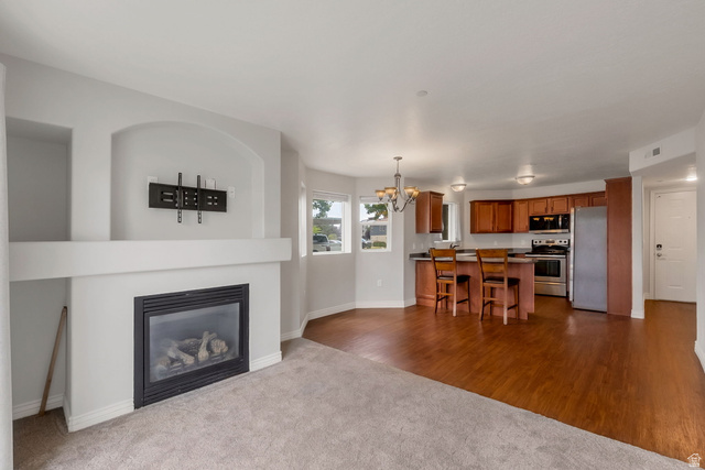 117 Calbourne Lane, Unit I2 Sandy, UT 84070 - Photo 2 of 19 Newer Carpet. LVP Flooring in Semi Formal Dining. Gas Fireplace.